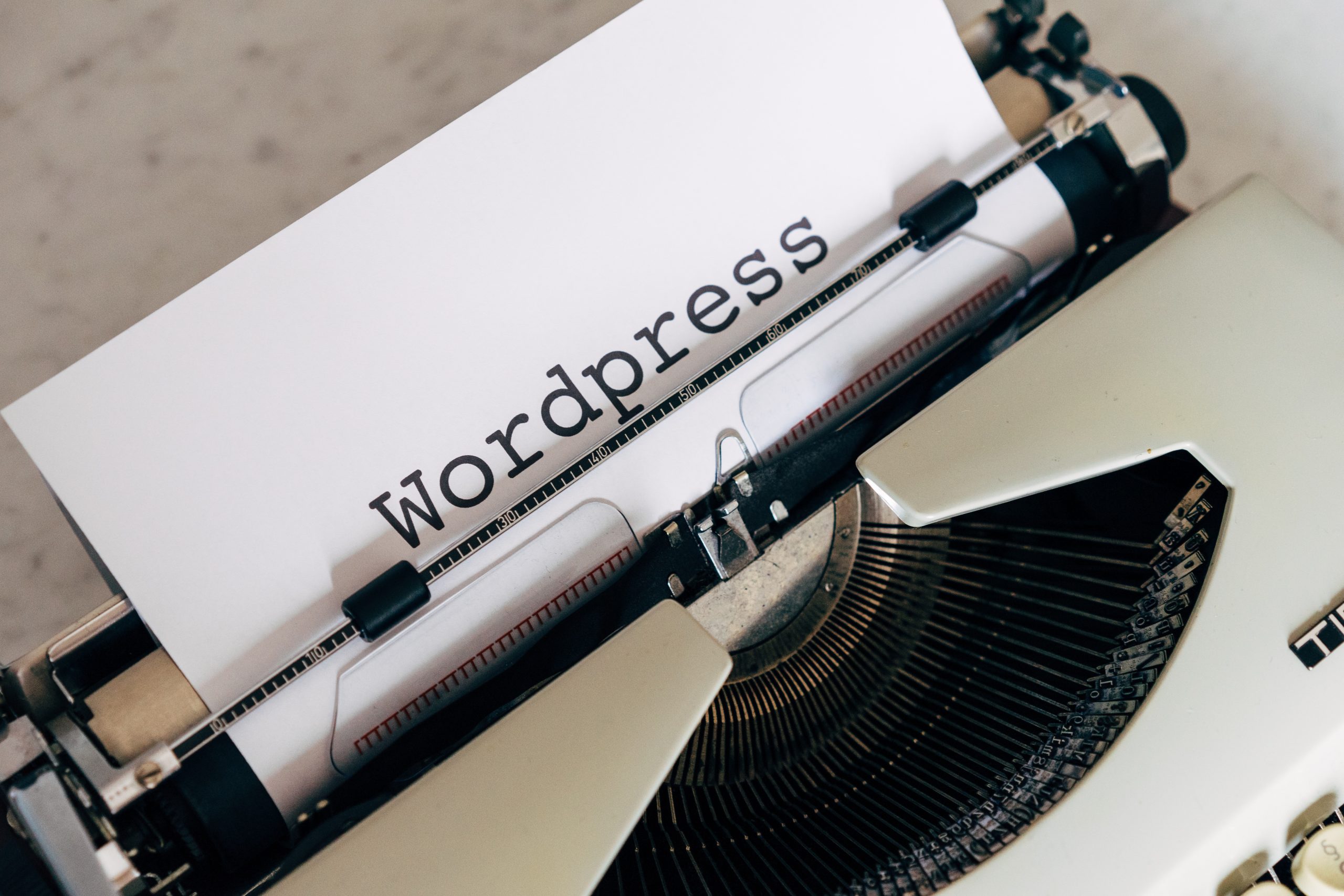 typewriter with the word wordpress showing